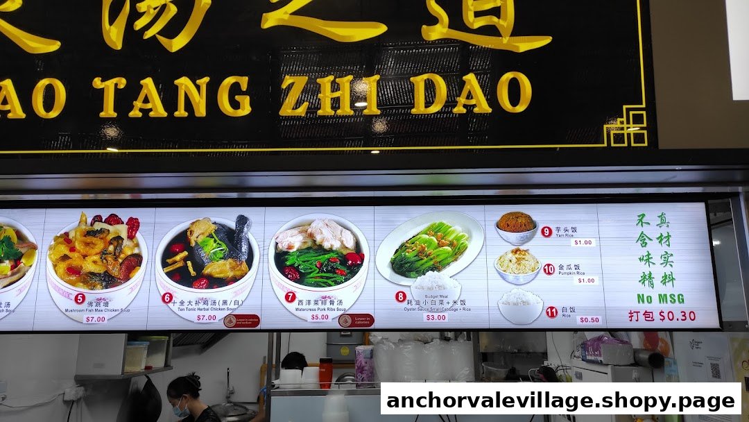 A brightly lit menu board displaying various traditional Chinese soups and rice dishes with prices.