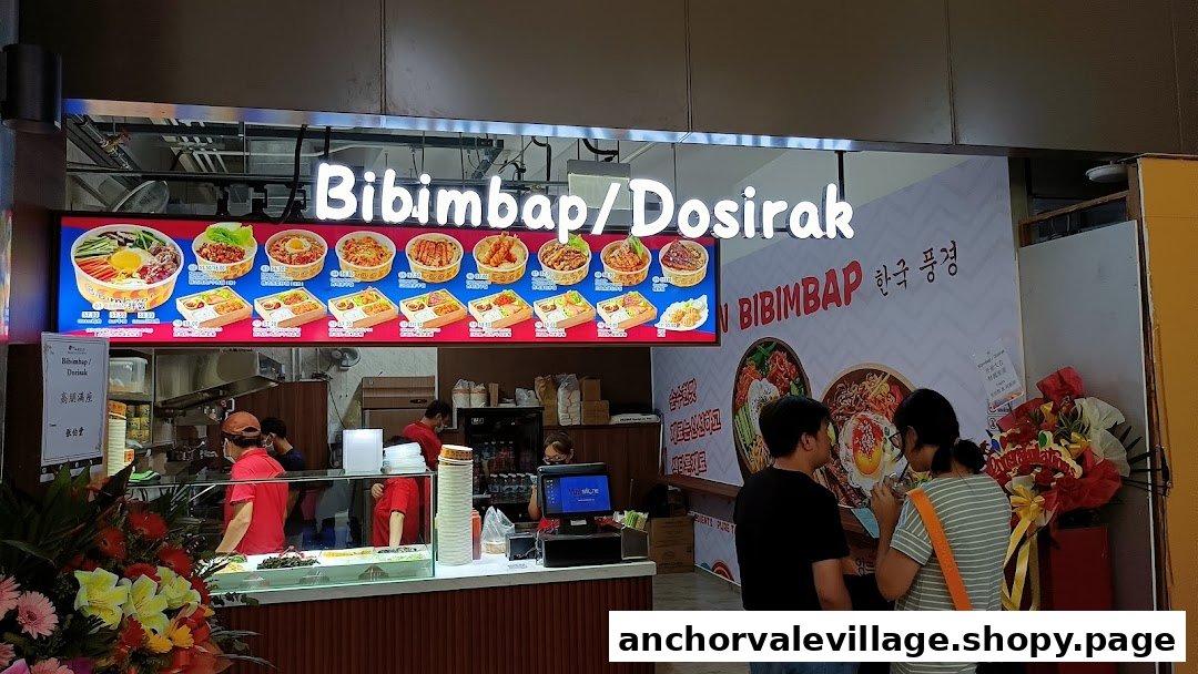 A vibrant Korean eatery, Bibimbap Dosirak, showcasing its menu board and bustling counter with staff and customers.