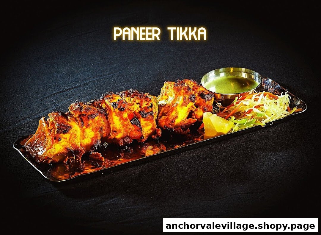 A vibrant plate of Paneer Tikka with fresh salad and green chutney, ready to be enjoyed.