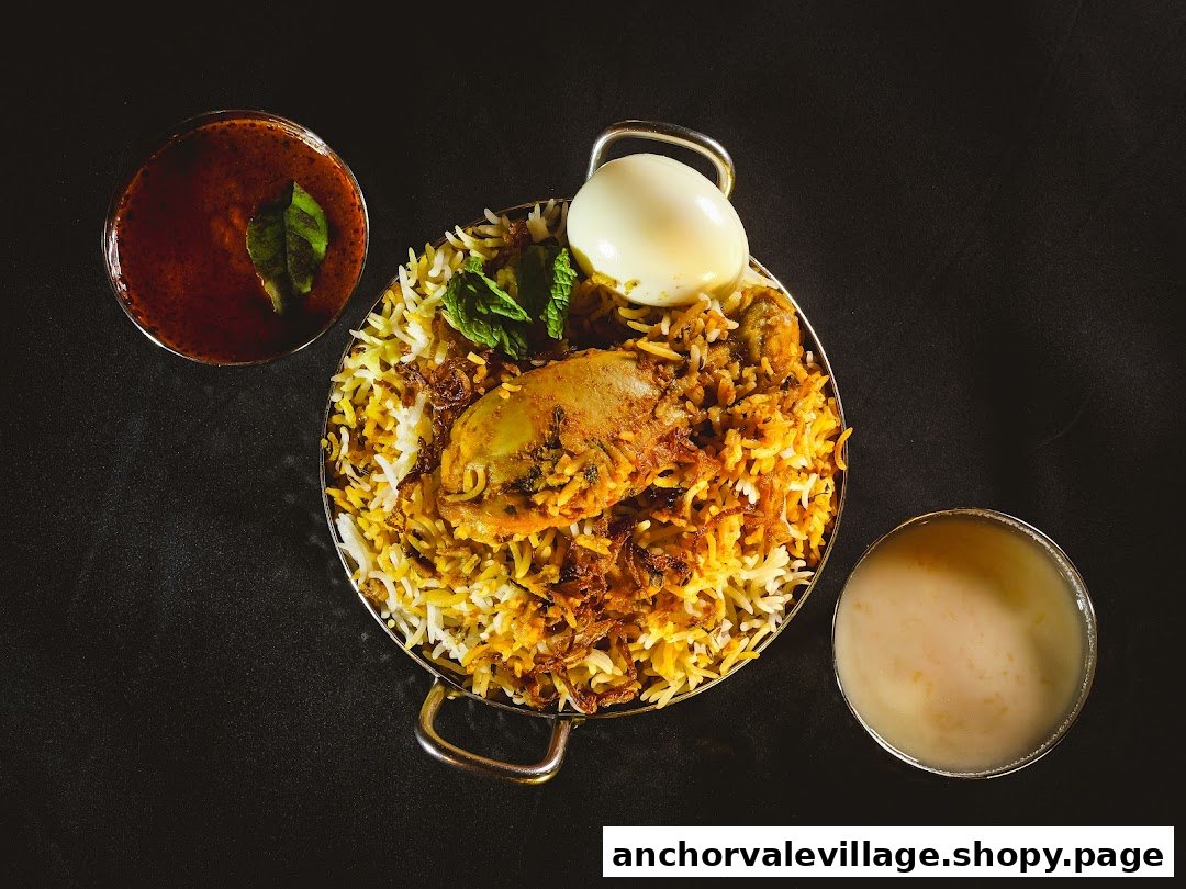 A vibrant overhead shot of chicken biryani served with a boiled egg, raita, and gravy.
