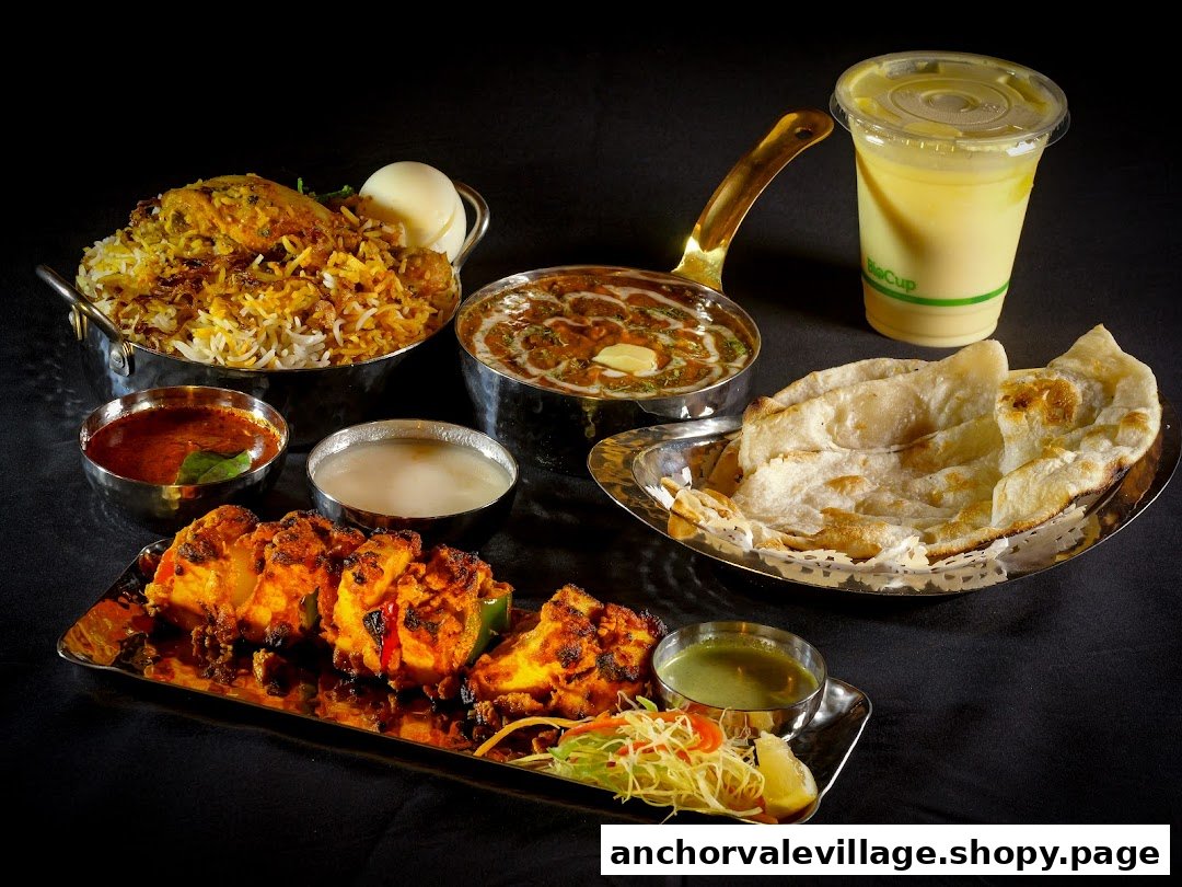 A vibrant spread of Indian cuisine featuring biryani, curry, paneer tikka, naan, and a refreshing drink.