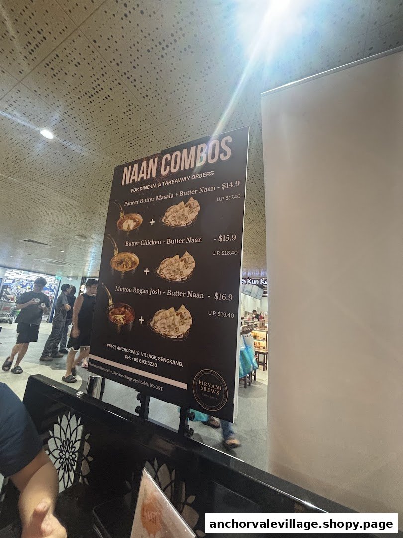 A menu board displaying Naan Combos with prices and contact information for Biryani Brews.