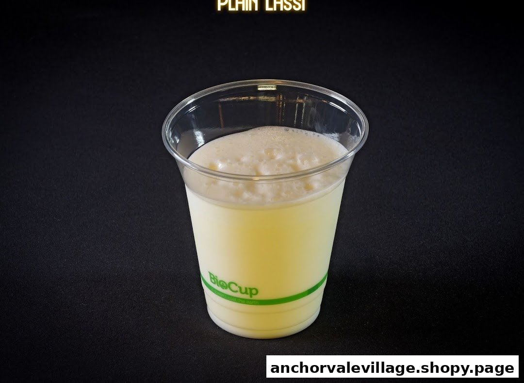 A refreshing plain lassi served in a clear BioCup against a dark background.