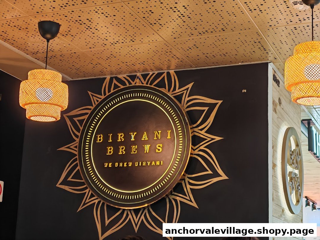 Interior view of Biryani Brews showcasing its illuminated brand logo and decorative lighting.