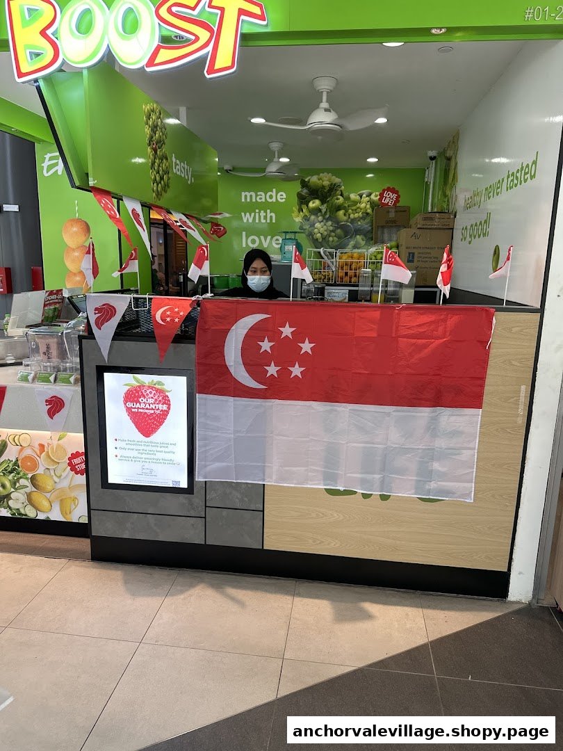A Boost Juice Bars counter with a staff member, decorated with Singapore flags.