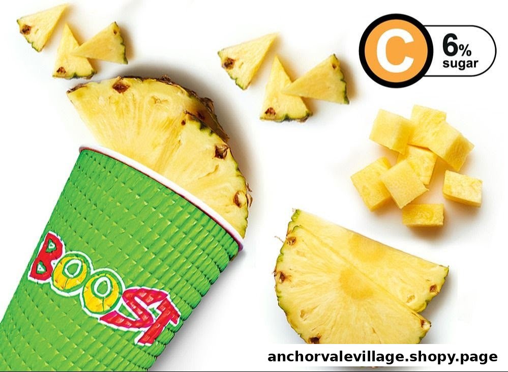 A vibrant Boost Juice cup surrounded by fresh pineapple slices and chunks, highlighting healthy ingredients.