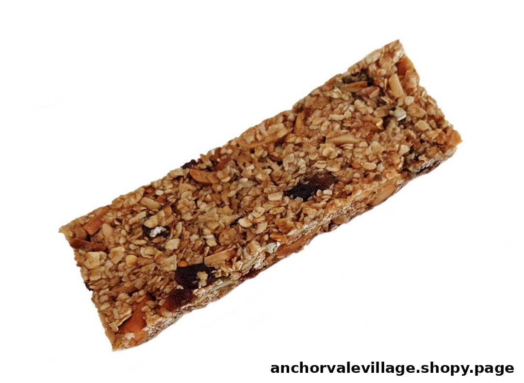 A close-up of a healthy granola bar with oats, nuts, and dried fruit.