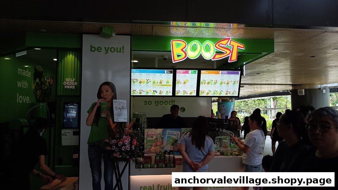 The vibrant green Boost Juice Bars shop front, featuring its prominent logo, digital menu boards, and customers.