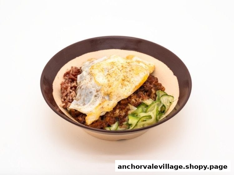A hearty breakfast bowl featuring rice, savory minced meat, fresh cucumber, and a perfectly fried egg.