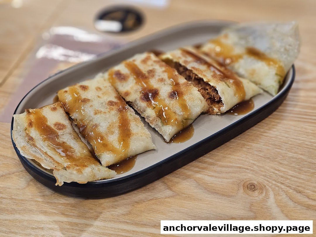 Savory pancakes with meat floss filling and sauce, served on a platter.