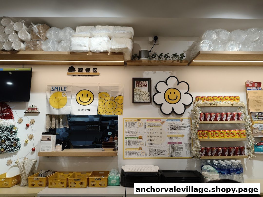 Interior view of a breakfast shop with a menu board, drinks, and a collection point.