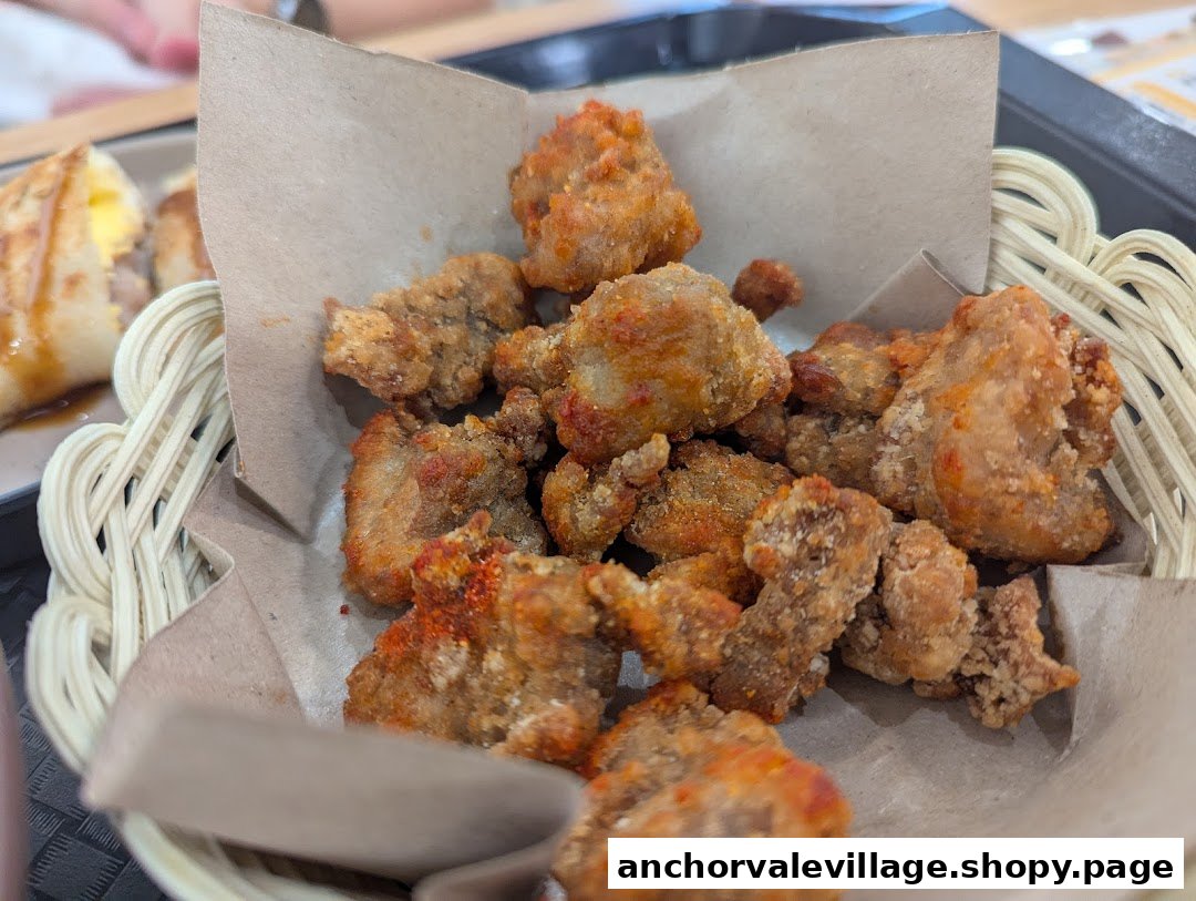 Close-up of crispy fried chicken pieces served in a woven basket with paper lining.