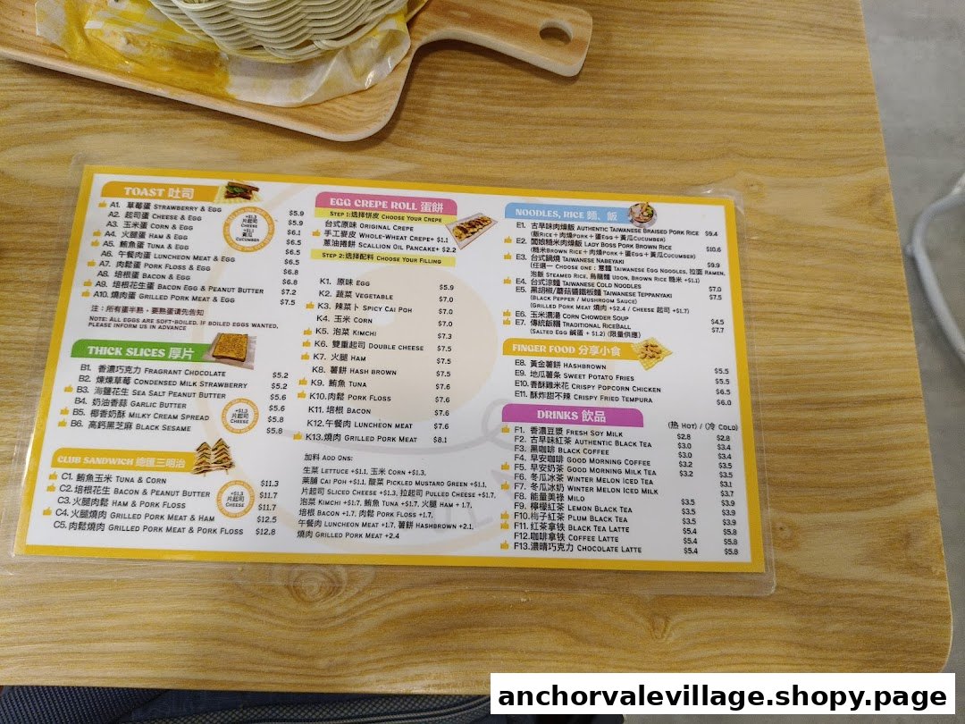 A comprehensive menu displaying various breakfast and brunch items including toasts, egg crepes, noodles, rice dishes, finger food, thick slices, club sandwiches, and drinks.