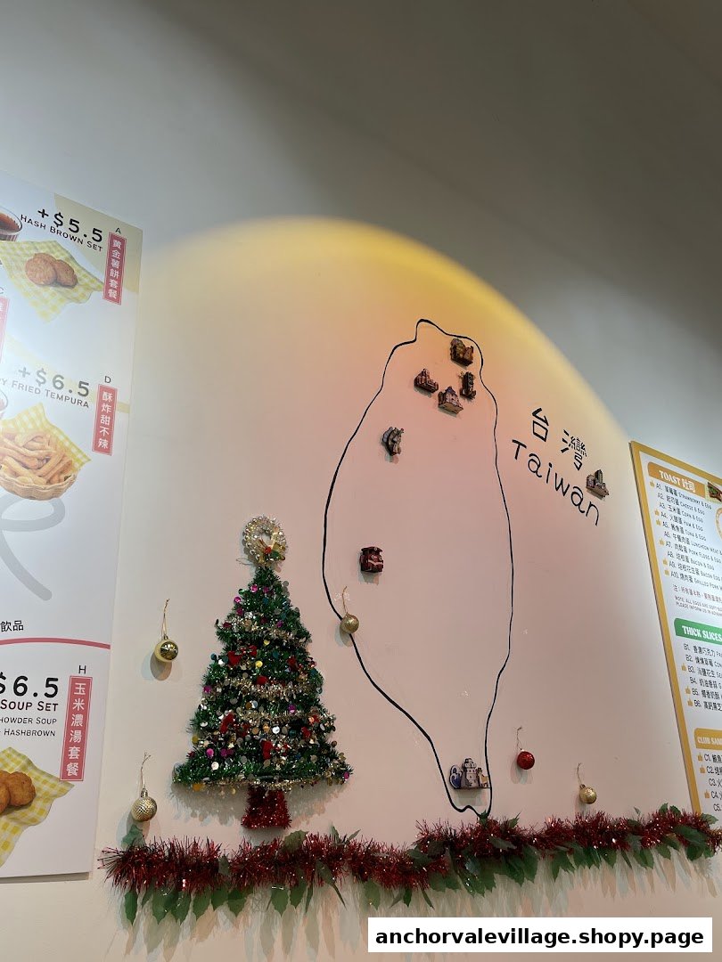 A festive interior wall featuring a Taiwan map decoration, a Christmas tree, and partial menu displays.