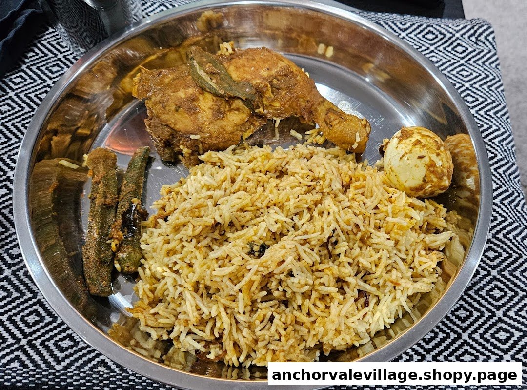 A close-up of a delicious biryani plate with chicken, egg, and okra.
