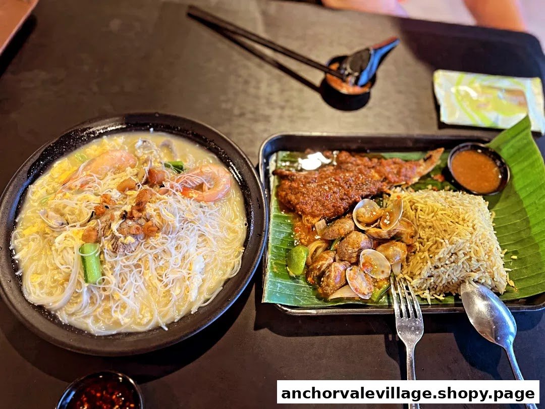 Two delicious seafood dishes, including noodles and a rice platter, served on a dark table.