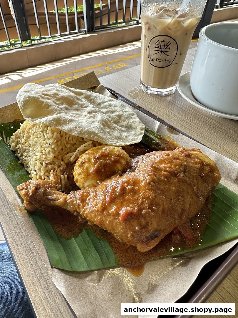 A flavorful chicken and rice dish with eggs and papadum, served on a banana leaf.