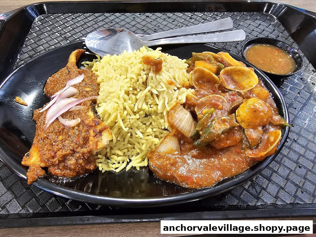 A vibrant plate featuring biryani rice, spicy fish, and clams in sauce, served on a black tray.