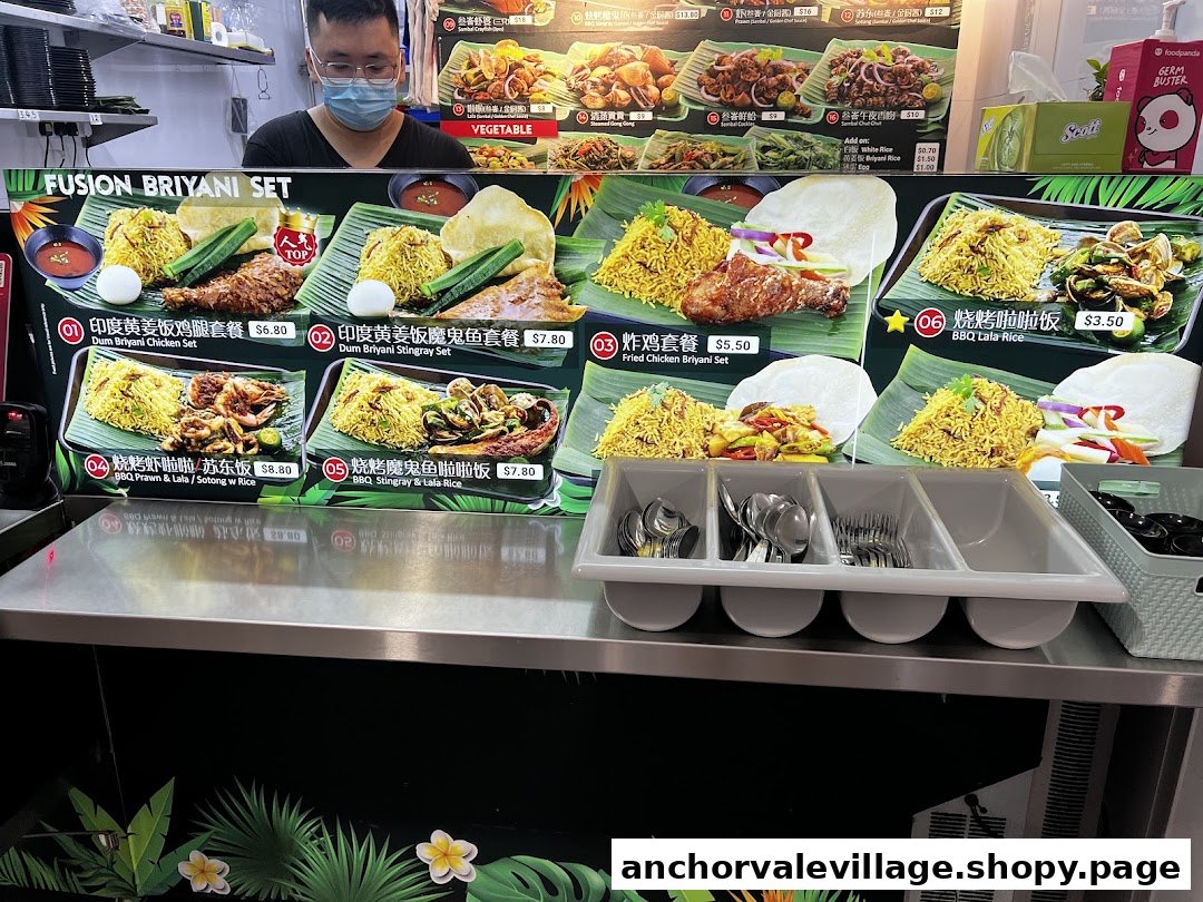 A food stall counter displaying a vibrant menu board with various biryani sets and BBQ dishes, with a staff member visible.