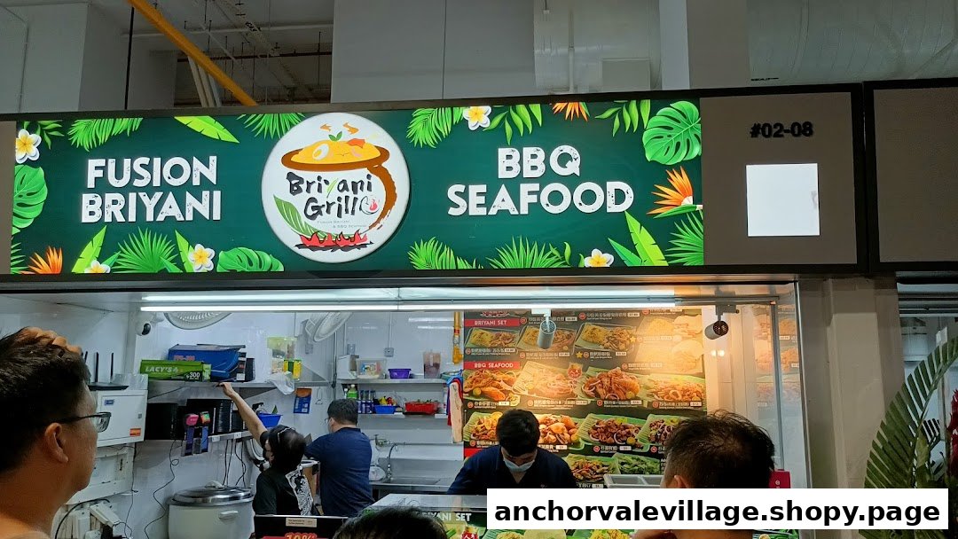 The counter of Briyani Grill food stall, showcasing its 'Fusion Briyani' and 'BBQ Seafood' offerings.