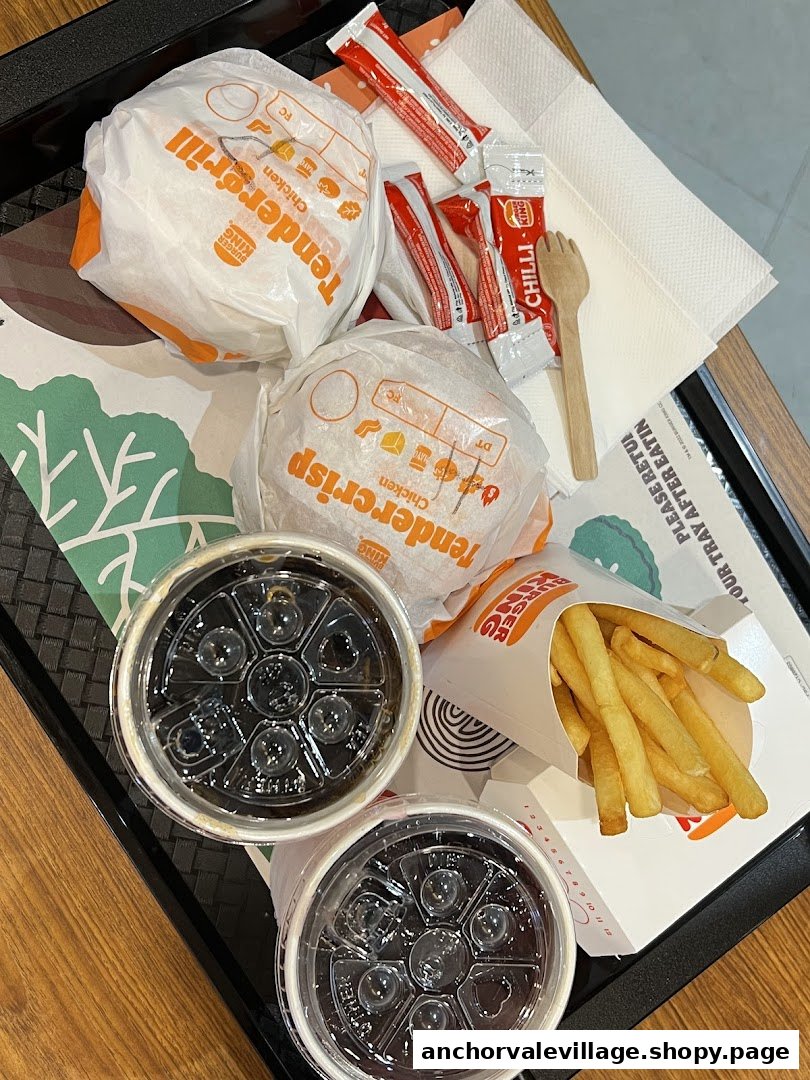 A tray with two Burger King burgers (Tendercrisp, Tendergrill), two drinks, and fries.