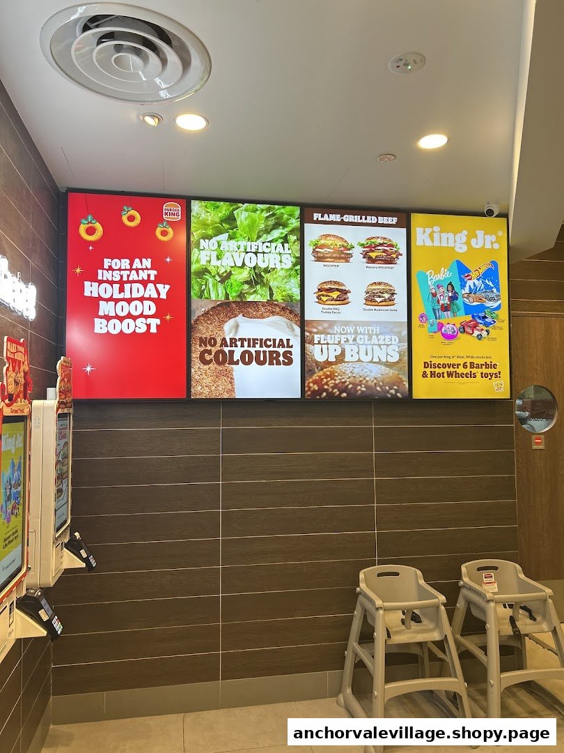 Interior view of Burger King featuring digital menu boards and high chairs.