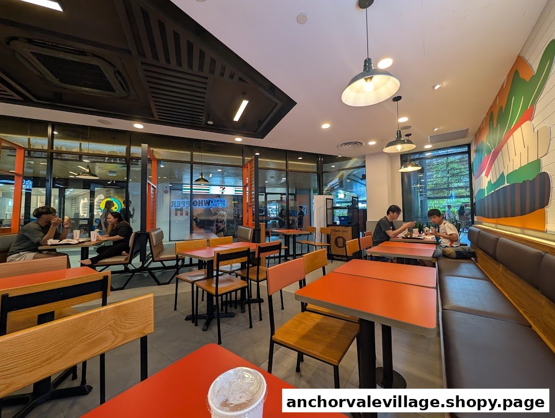 An interior view of Burger King showing customers dining and comfortable seating.