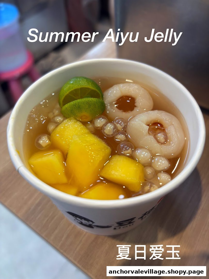 A refreshing bowl of Summer Aiyu Jelly with mango, lychee, and lime in a white cup.