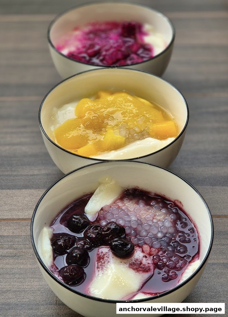 Three bowls of colorful dou hua (tofu pudding) with various fruit toppings and tapioca pearls.