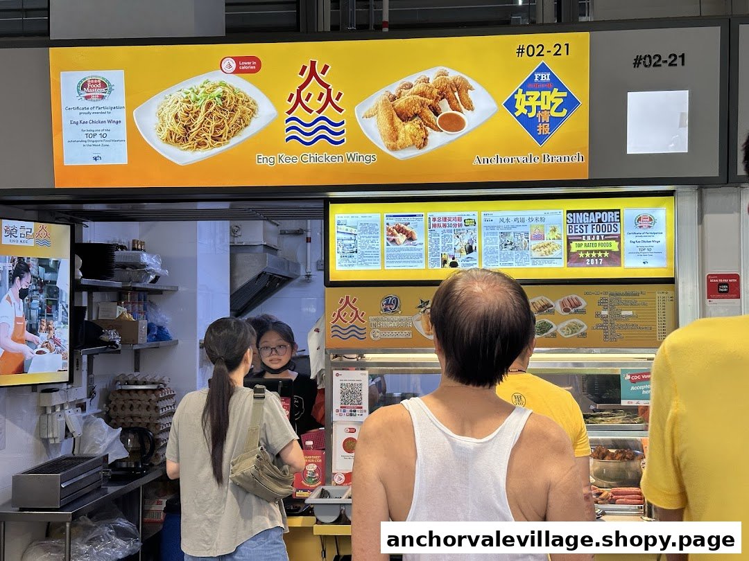 Customers at Eng Kee Chicken Wings counter with overhead signage displaying chicken wings and noodles.