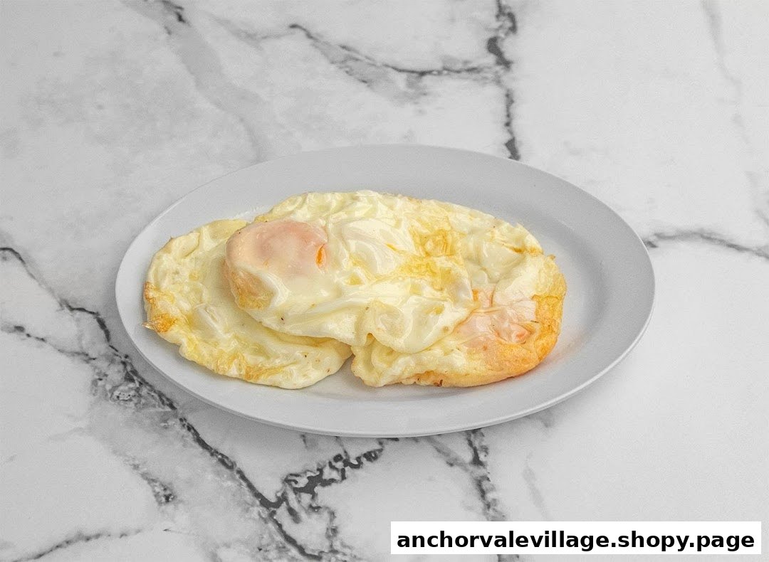 Two perfectly fried eggs with golden, crispy edges served on a white plate.