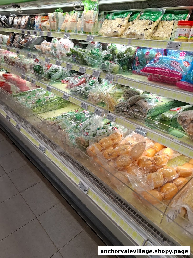Refrigerated display shelf at FairPrice Anchorvale Village, stocked with packaged vegetables and fresh produce.