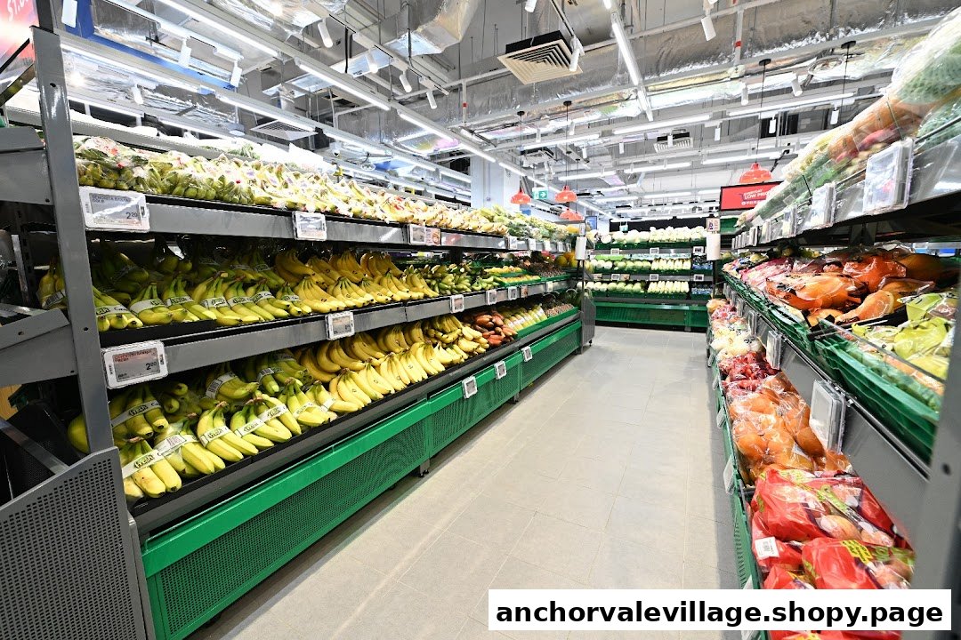 An aisle in FairPrice supermarket showcasing a wide variety of fresh fruits and vegetables.