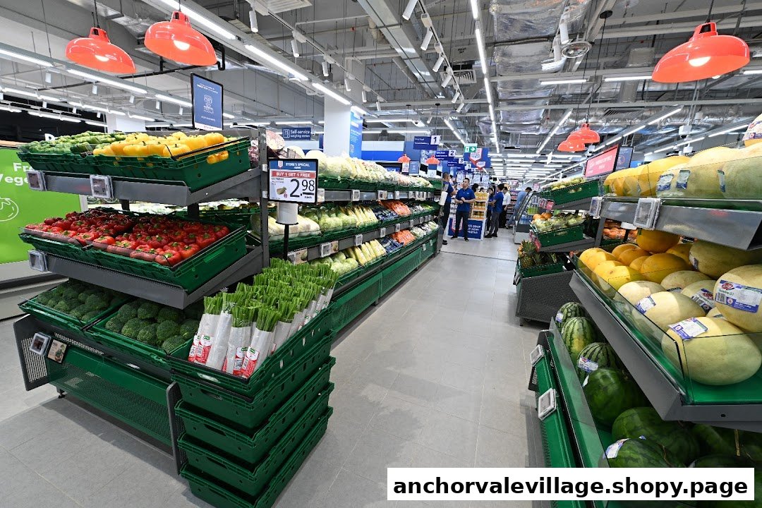 A brightly lit supermarket aisle showcasing a wide variety of fresh fruits and vegetables.