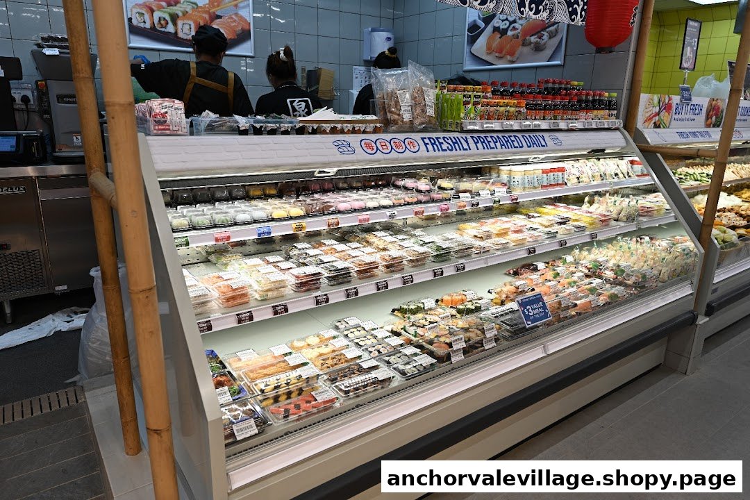 A refrigerated display case filled with freshly prepared sushi and Japanese food items at FairPrice Anchorvale Village.