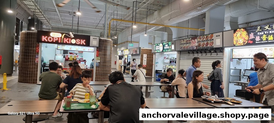 A vibrant food court at FairPrice Anchorvale Village with multiple food stalls and people dining.