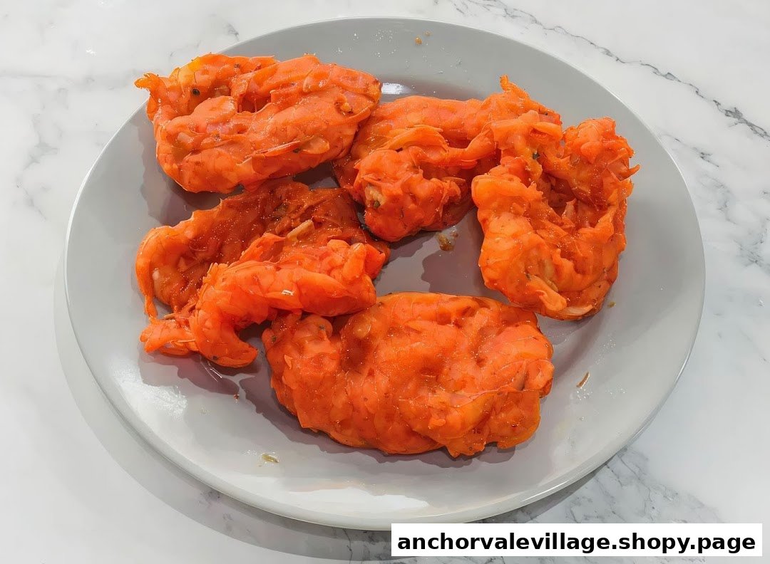 A plate of vibrant orange, crispy fried prawn fritters, a popular snack.