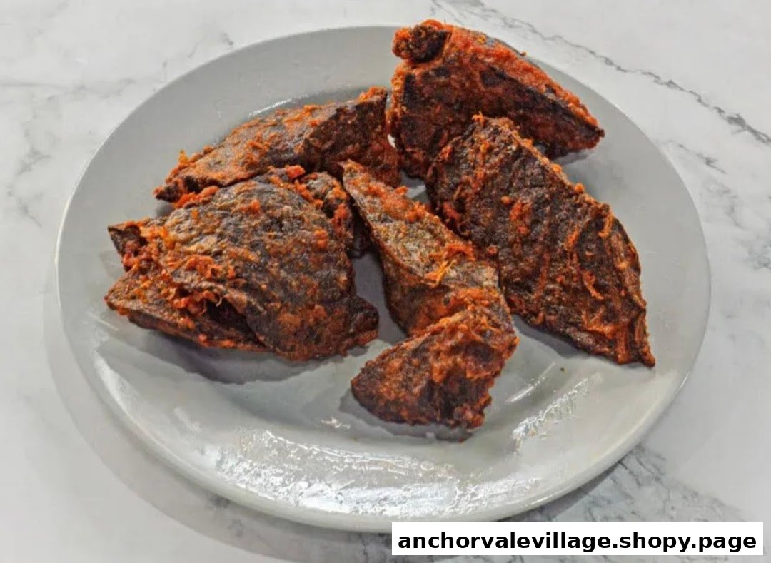 A plate of crispy, spicy fried items, likely a component of rojak, on a white plate.