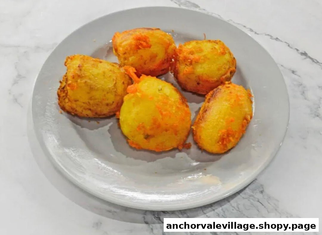 A plate of five golden-fried potato fritters or croquettes, possibly a side dish or snack.