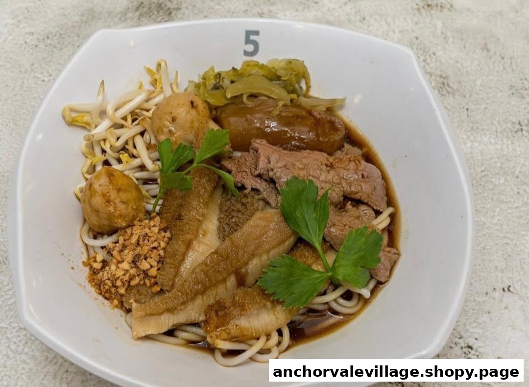 A close-up of a hearty bowl of beef noodles with various toppings and savory broth.