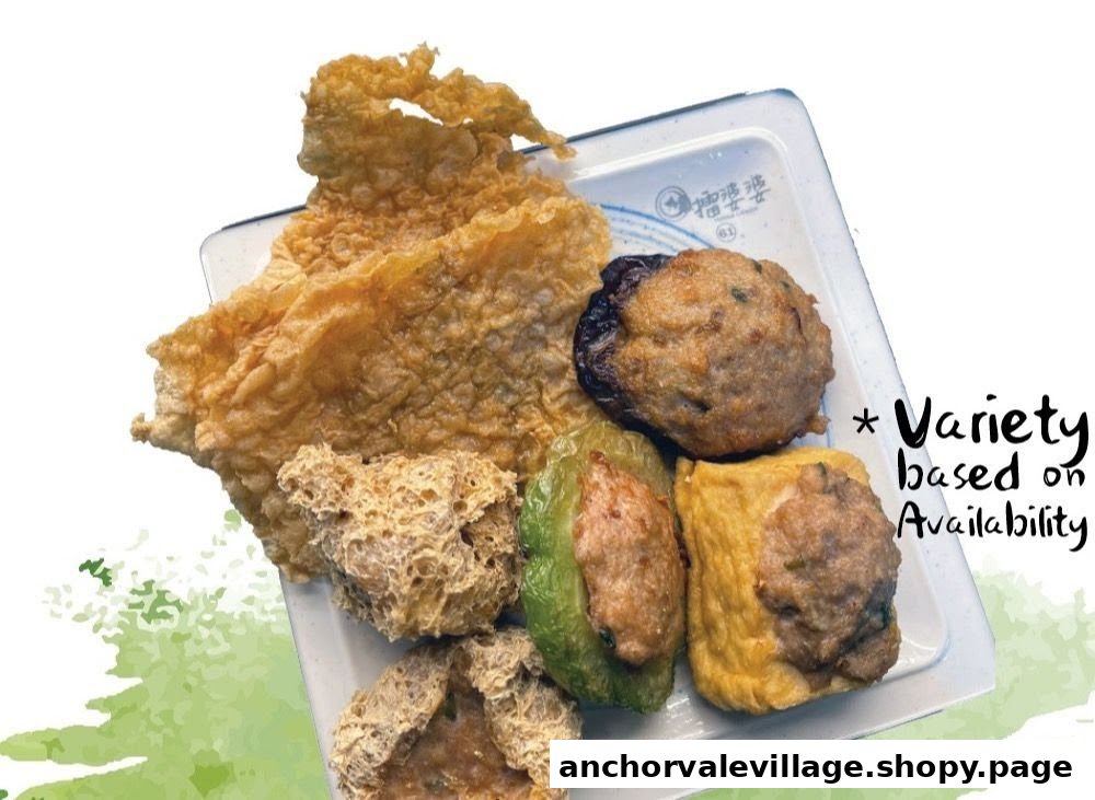 A plate of assorted Hakka Yong Tau Foo items, including stuffed vegetables, tofu, and crispy fried beancurd.