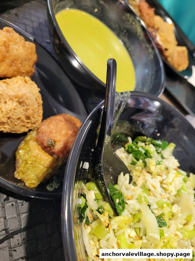 A close-up of traditional Hakka dishes, including Thunder Tea Rice and assorted Yong Tau Foo, served in black bowls.