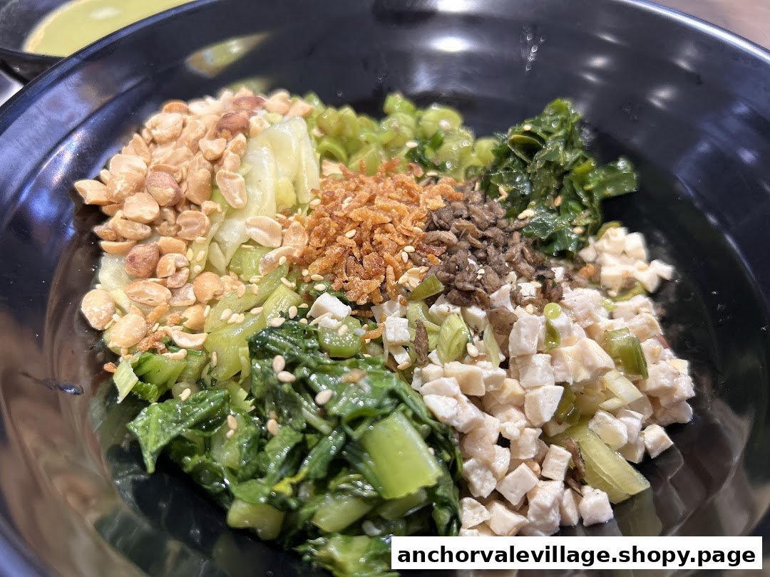 A close-up of a vibrant bowl of Hakka Lei Cha ingredients, featuring various vegetables, peanuts, and tofu.