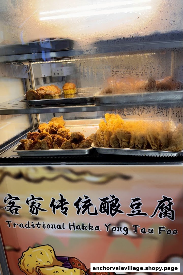 A display case showcasing various freshly fried traditional Hakka Yong Tau Foo items.