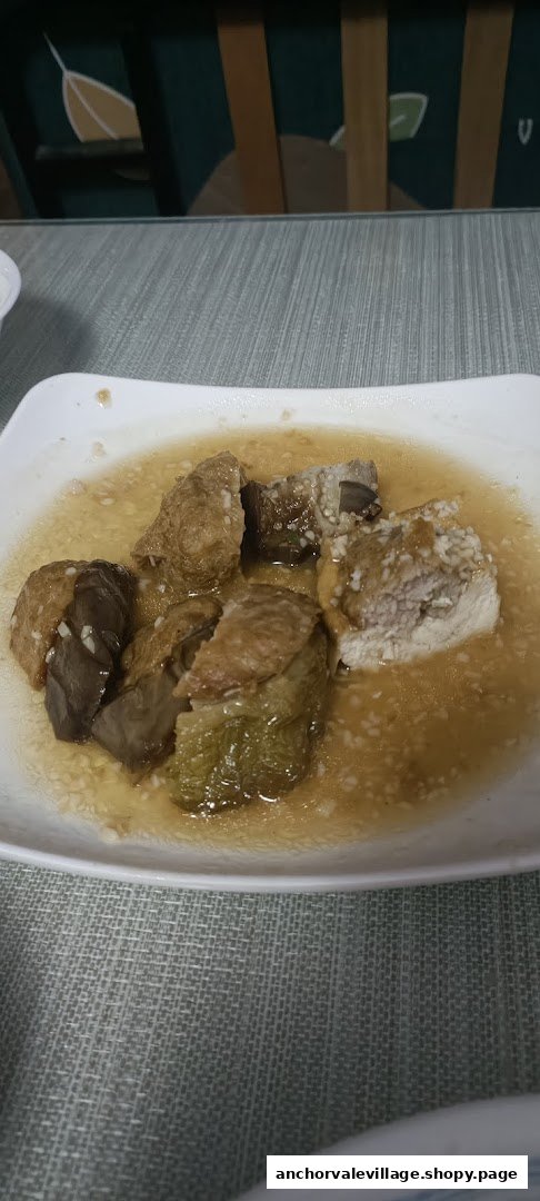 A plate of traditional Hakka Yong Tau Foo featuring various stuffed ingredients in a savory sauce.