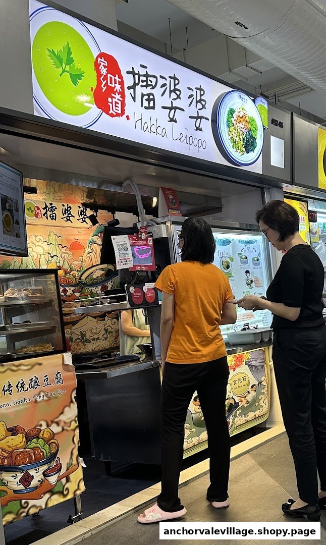 Customers ordering traditional Hakka cuisine at the Hakka Leipopo food stall counter.