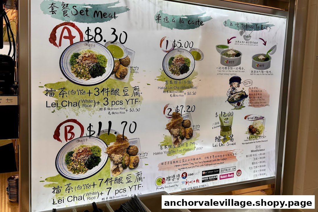 A brightly lit menu board displaying Hakka Lei Cha set meals, a la carte options, and side dishes.