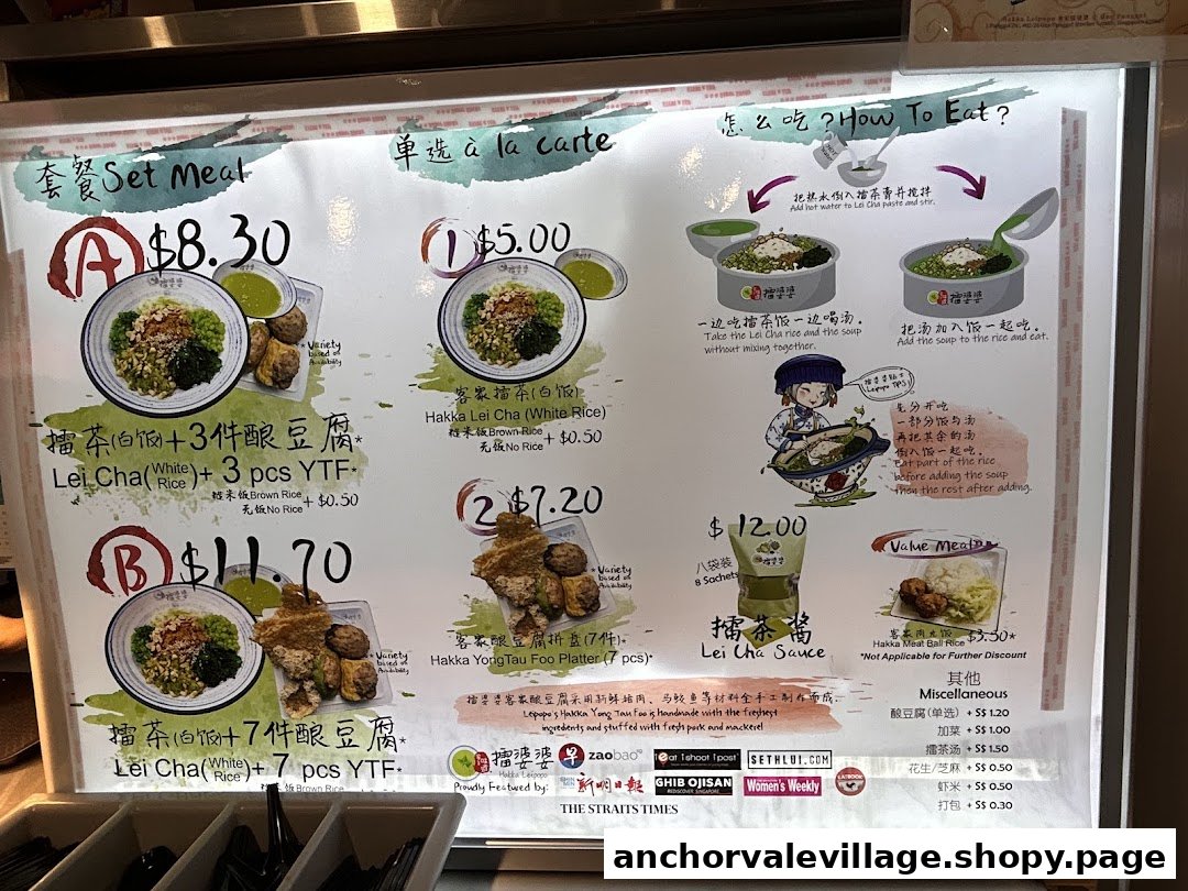 A brightly lit menu board displaying Hakka Lei Cha and Yong Tau Foo set meals and ala carte options.