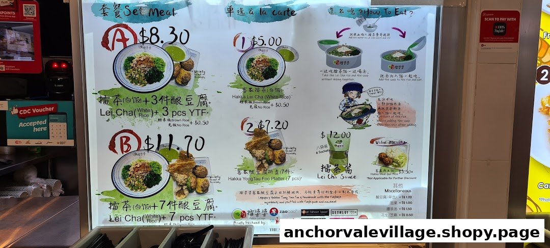 A brightly lit menu board displaying Hakka Lei Cha and Yong Tau Foo dishes with prices and instructions.