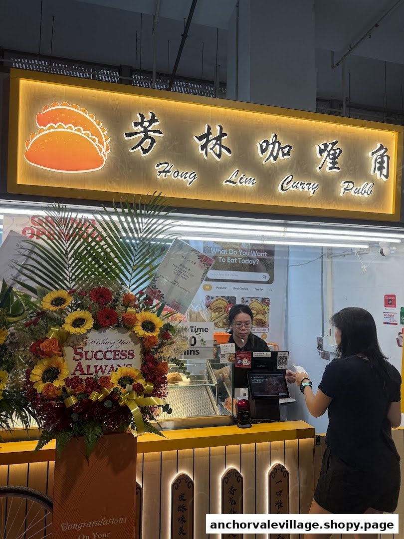 The vibrant shop front of Hong Lim Curry Puff, featuring a customer at the counter and a floral arrangement.